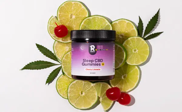 Image displays a jar of Sleep CBD Gummies in Cherry Limeade flavor, surrounded by lime slices, cherries, and cannabis leaves.